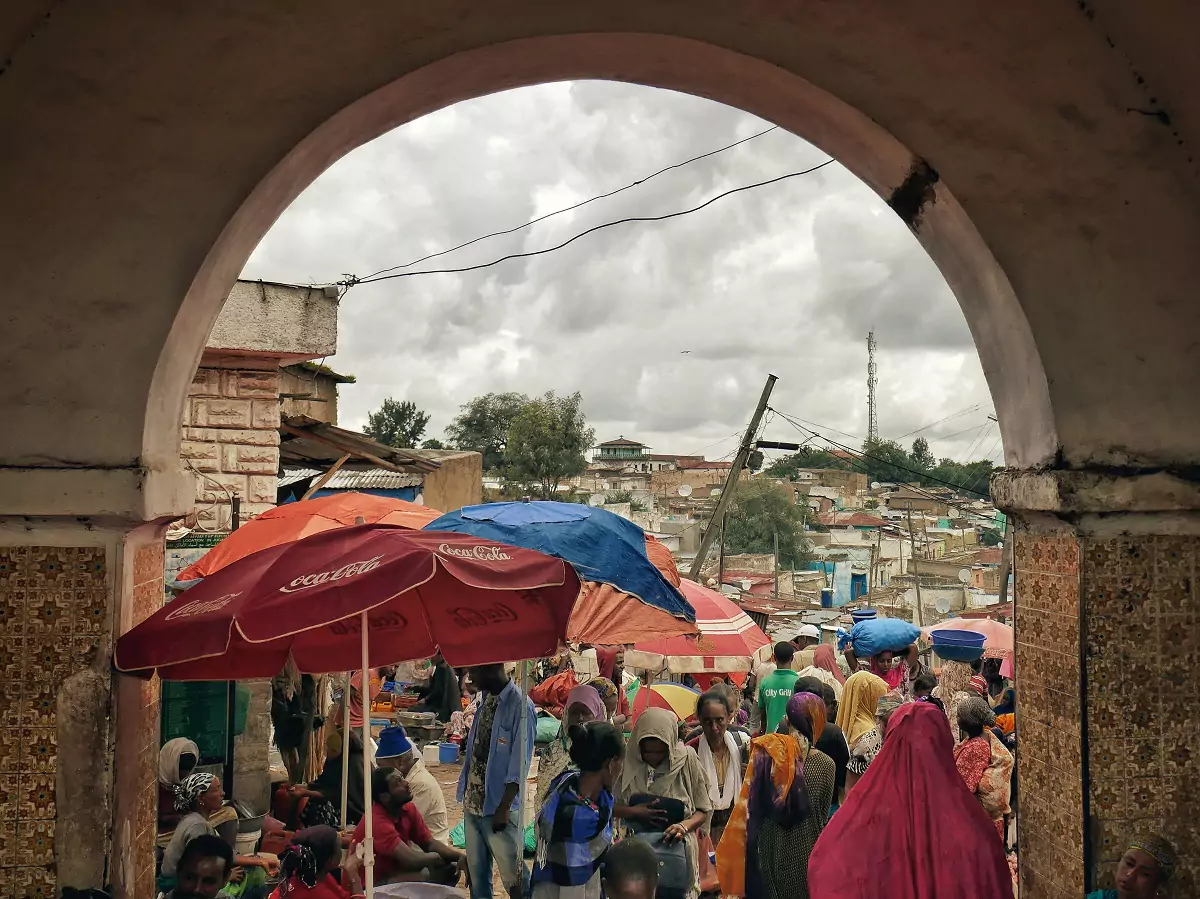 A busy market with vendors and customers milling around the stalls in Harar, Ethiopia.