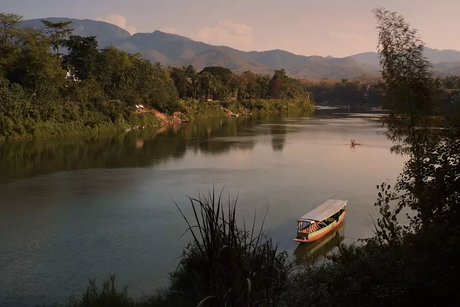 Blue waters of the Nam Khan river flowing through Luang Prabang in Laos.