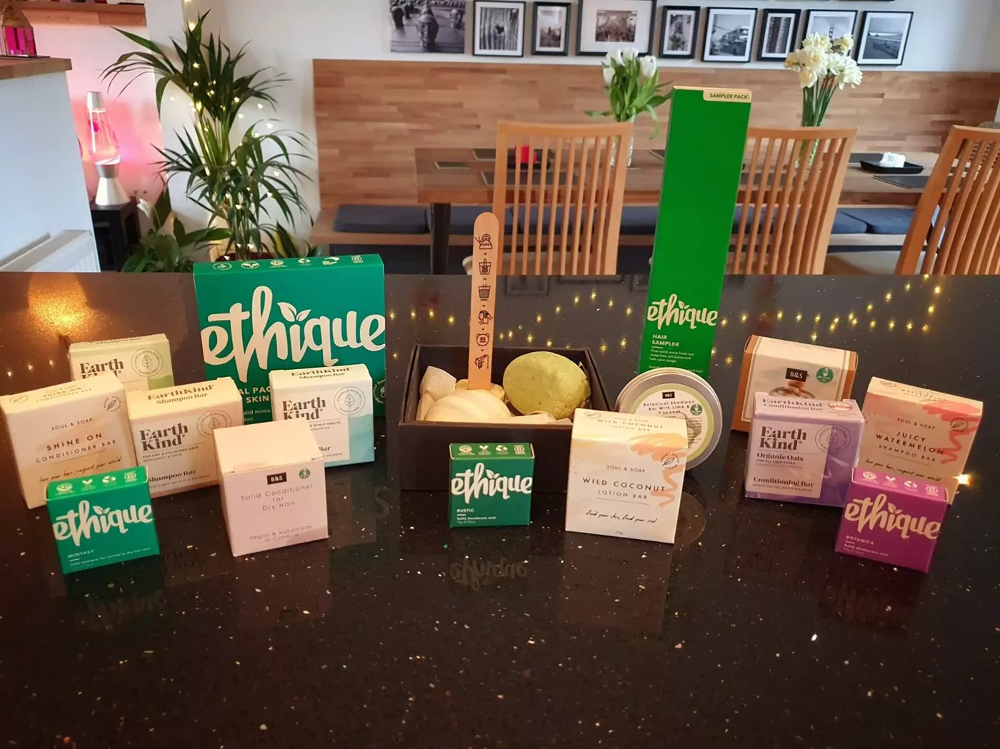 A selection of solid shampoo and conditioner bars on a kitchen worksurface, demonstrating a wide availability.