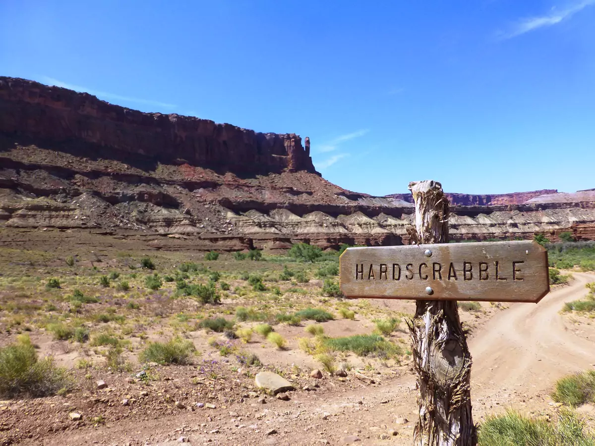 A wooden sign for the Hardscrabble section of the White Rim Road, nailed to a piece of wood.