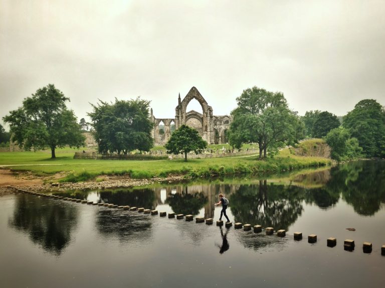 Walking across the stepping stones at Bolton Abbey