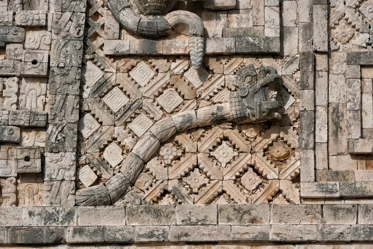 Ornate snake carvings on a structure at the Mayan ruins at Uxmal, showing an interesting 'mosaic block-tile' architectural style.