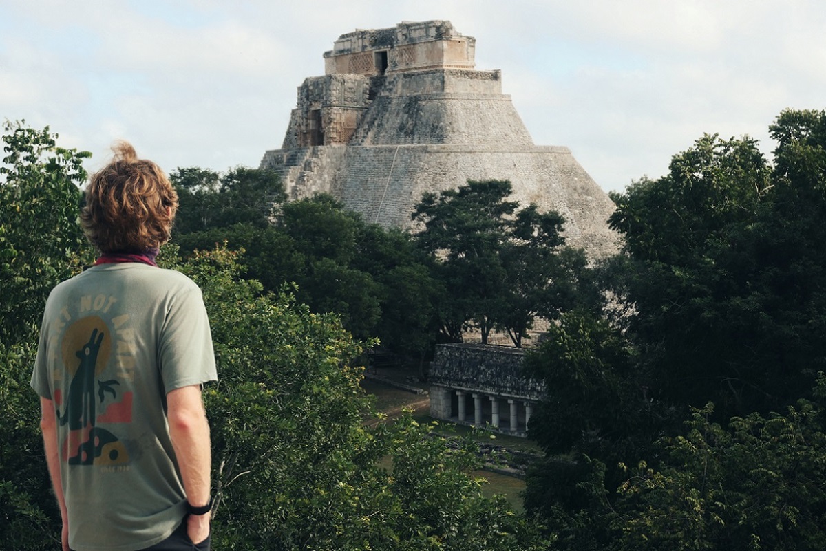 The prominent Pyramid Of The Magician surrounded by jungle trees at Uxmal.