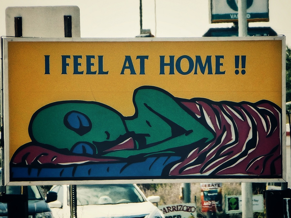 Sign of an alien feeling at home outside a hostel