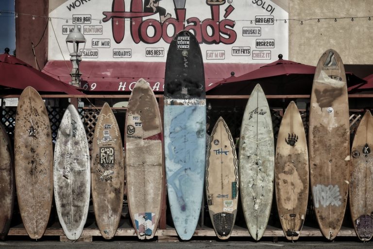 Surfboards in a line outside a surf shop