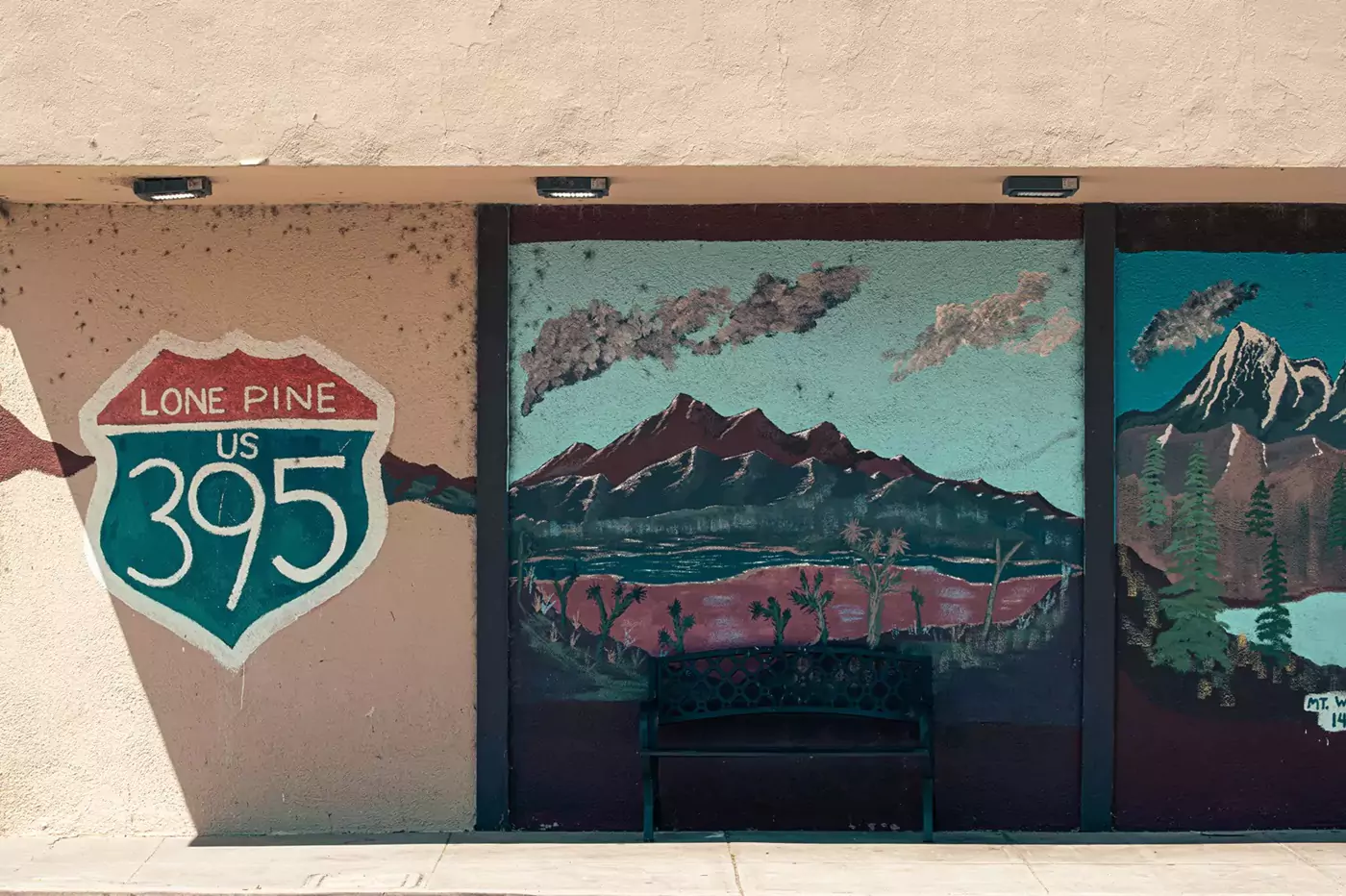 A painted mural on the side of a grocery store of the route 395 emblem.