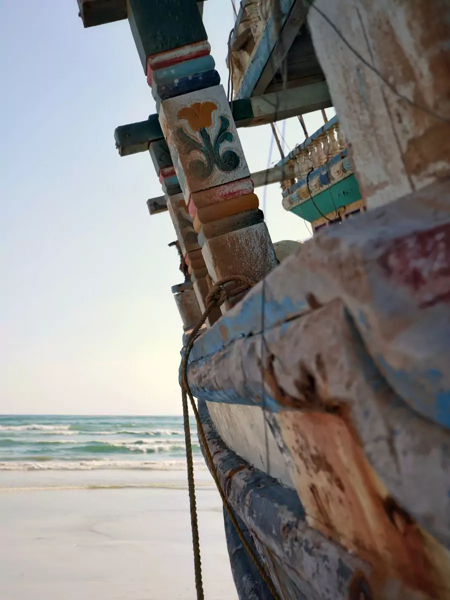 Side of an abandoned dhow fishing vessel on a beach at Masirah Island, Oman.