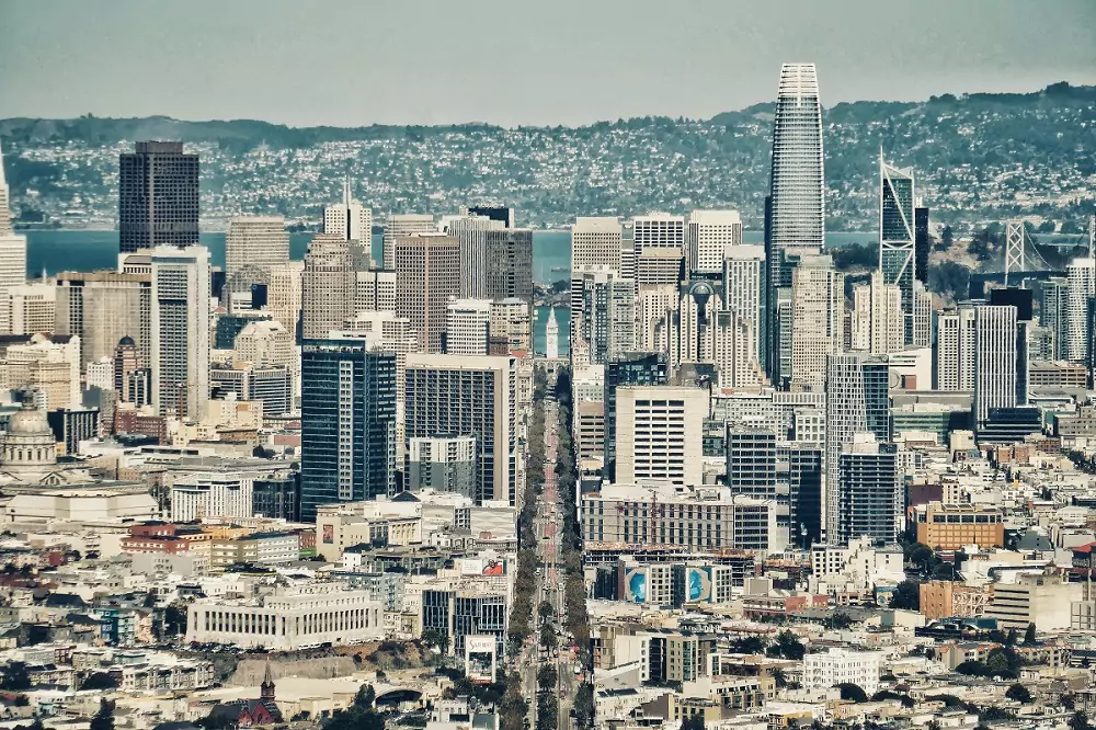 Skyline of San Francisco with a road running straight through the city, dividing it.