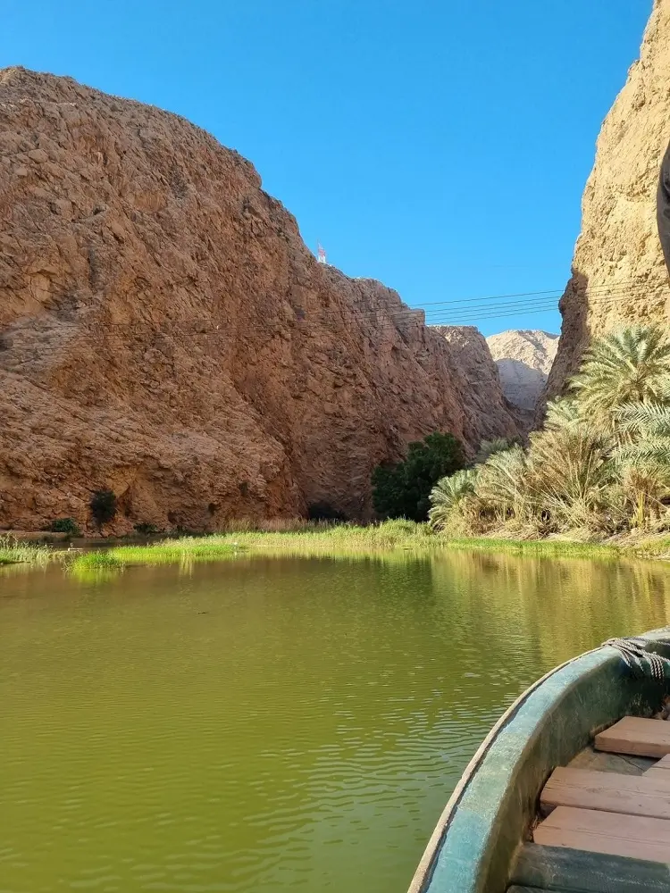 A boat riding towards the entrance of the canyon at Wadi Shab