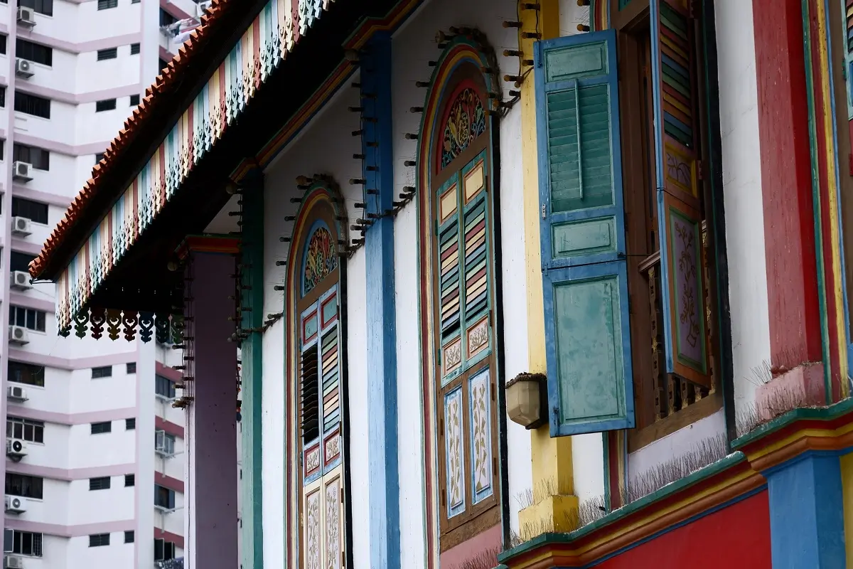 Vibrant coloured wooden window shutters on display in Little India in Singapore