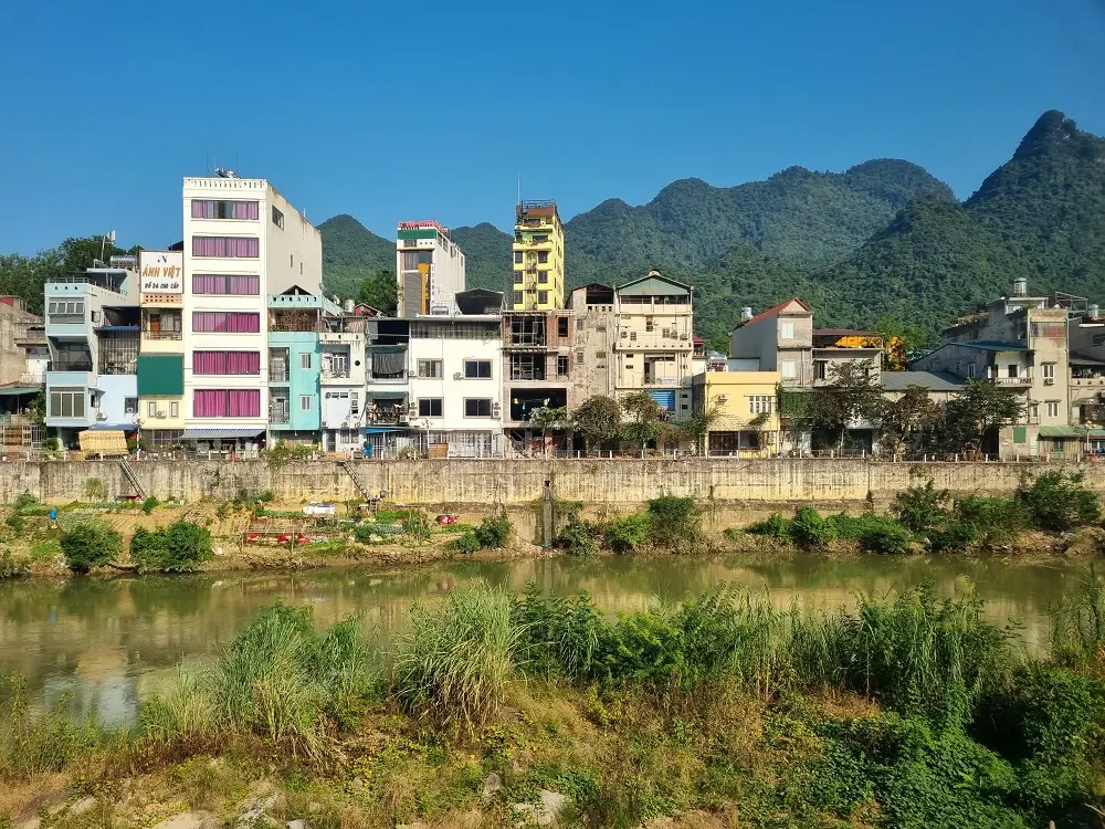 Colourful buildings by the river Lo in the town of Ha Giang, Vietnam where riders start their Ha Giang loop.