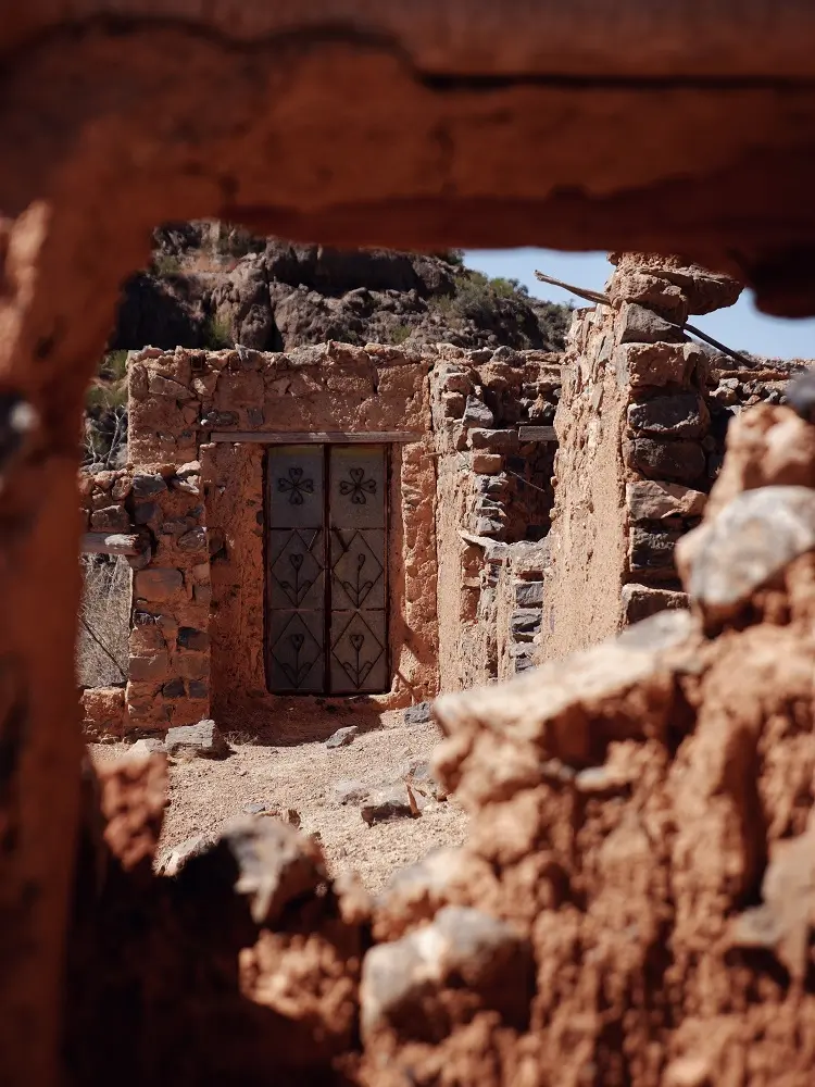 A sturdy decorated door among the ruins at Wadi Bani Habib in Jebel Akhdar, Oman.