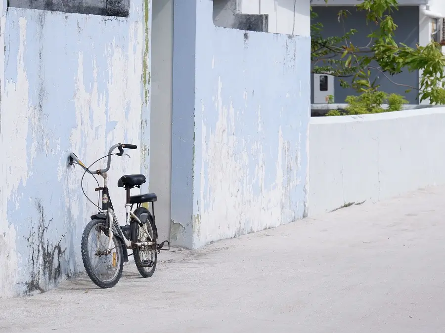 An unchained bike leaning against a wall in Thulusdhoo in the Maldives.