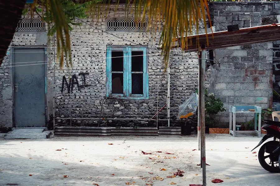 A window frame painted blue on a brick built house in Thulusdhoo.