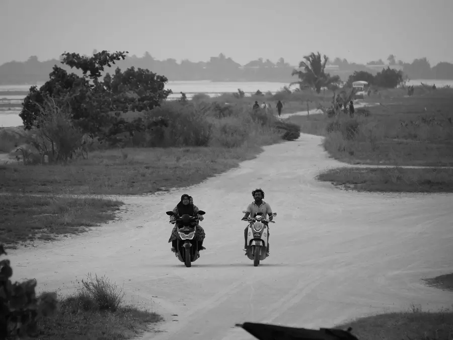 Motorcyclists driving along a coastal road on Thulusdhoo.