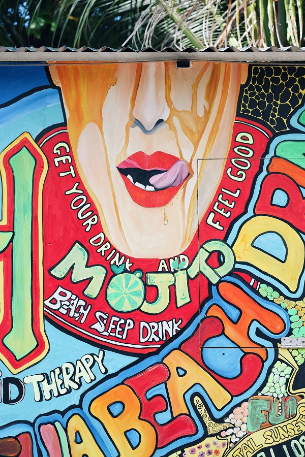 A colourful mural on the wall of a beach bar.