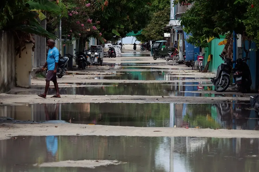 Reflections in puddles along the main street of Ukulhas.