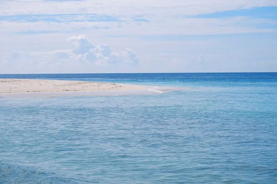 A stretch of sand reaching into the sea on the shore of Ukulhas.