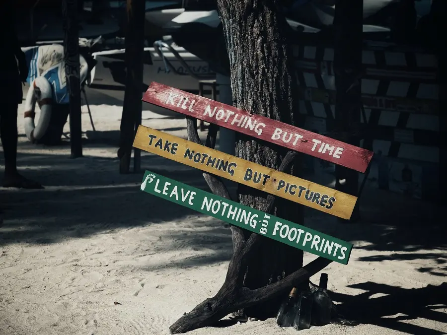A multicoloured sign regarding the practice of leave no trace, found on the island of Maafushi in the Maldives.