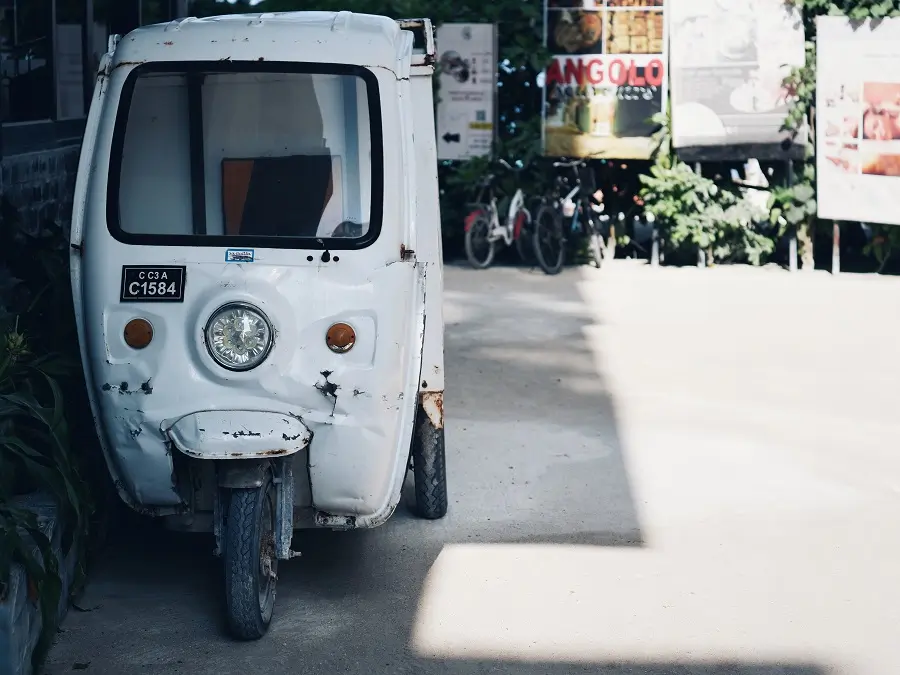 A white tuk tuk used for deliveries on Maafushi in the Maldives.
