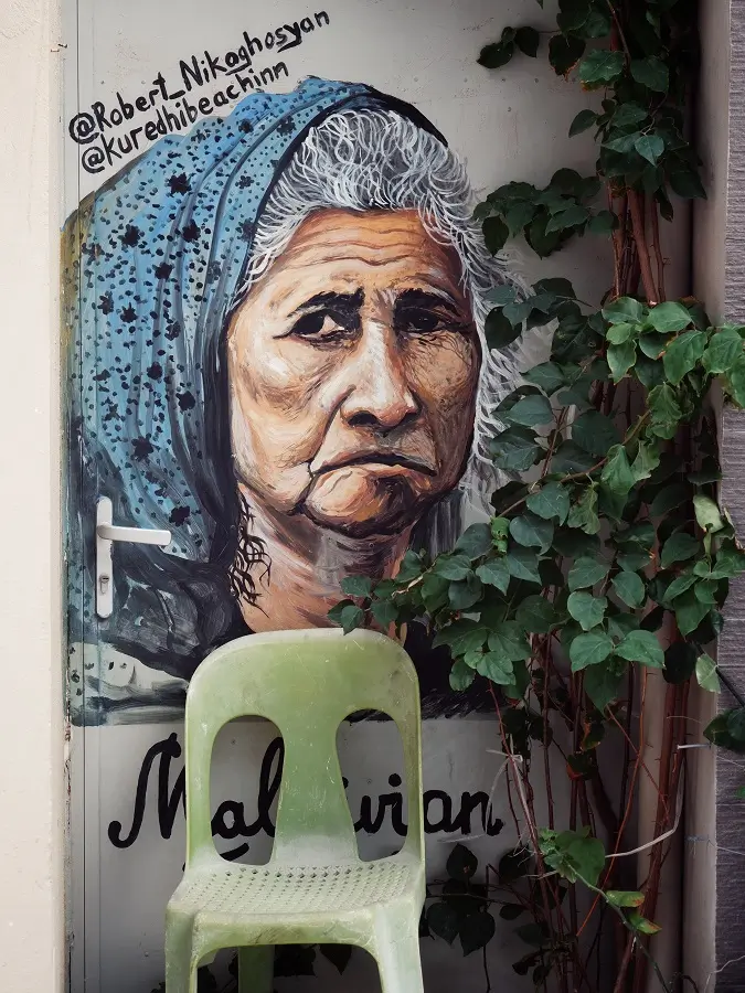Wall art of an old lady on the streets of Maafushi, Maldives.