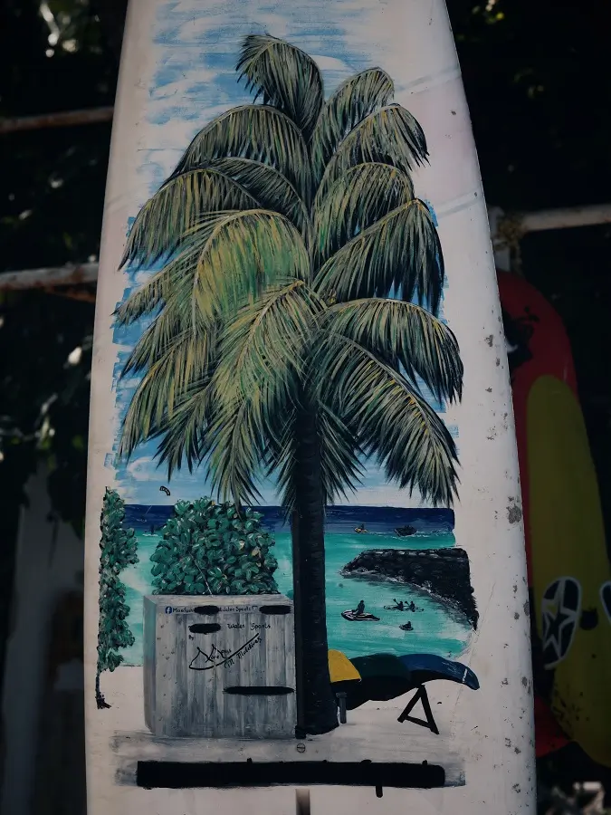 Art on a surfboard by the beach of Maafushi, Maldives.