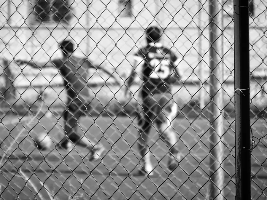 Footballers training in a fenced off football pitch in Amman, Jordan.