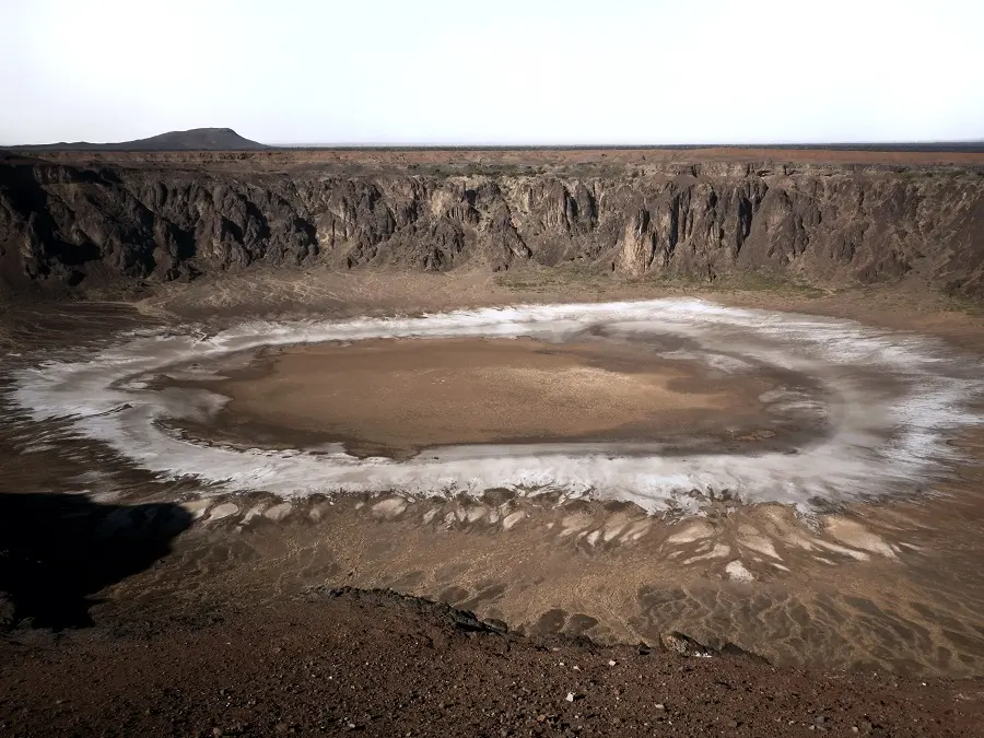 White ring of salt deposits in the crater at Al Wahbah, Saudi Arabia.