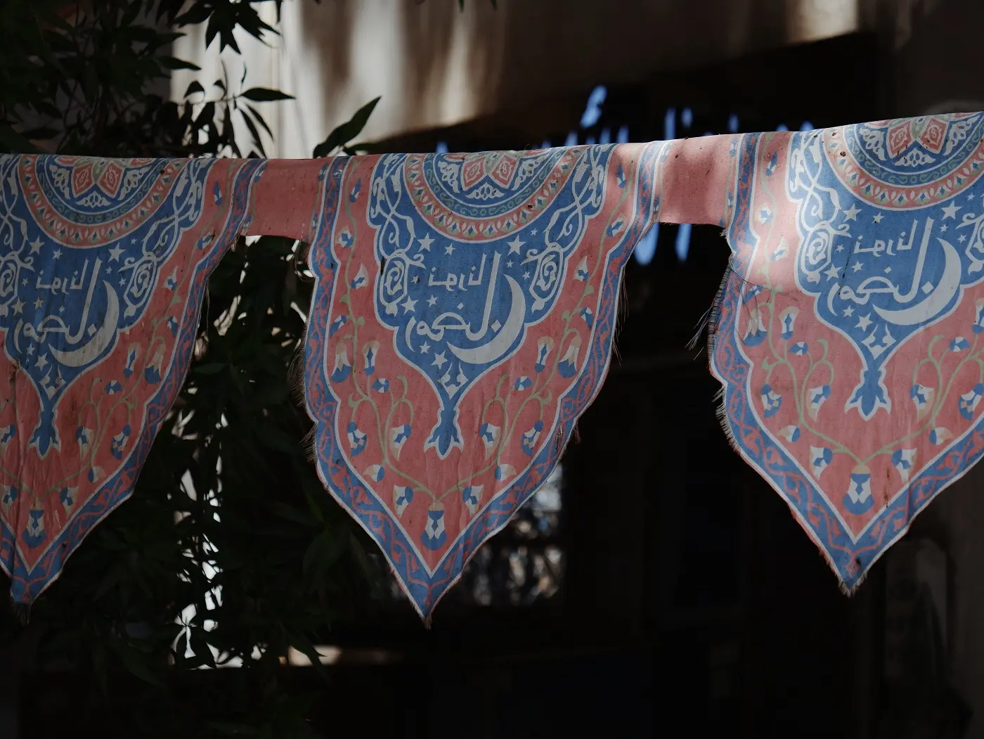 Blue and red emblems hanging in Al Balad in Jeddah.