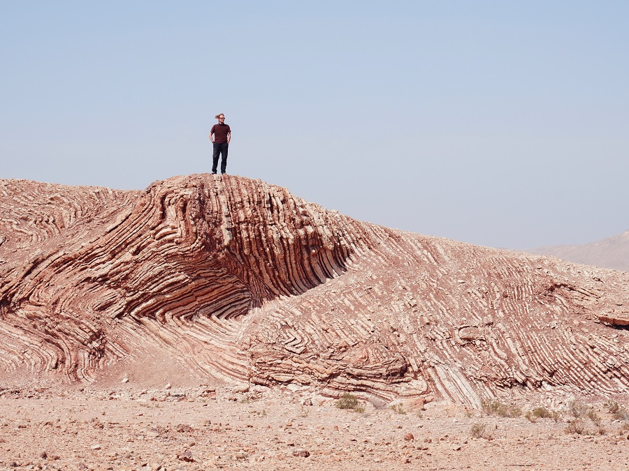 A striped rock formation 'The mother of all outcrops' located outside of Sur, Oman.
