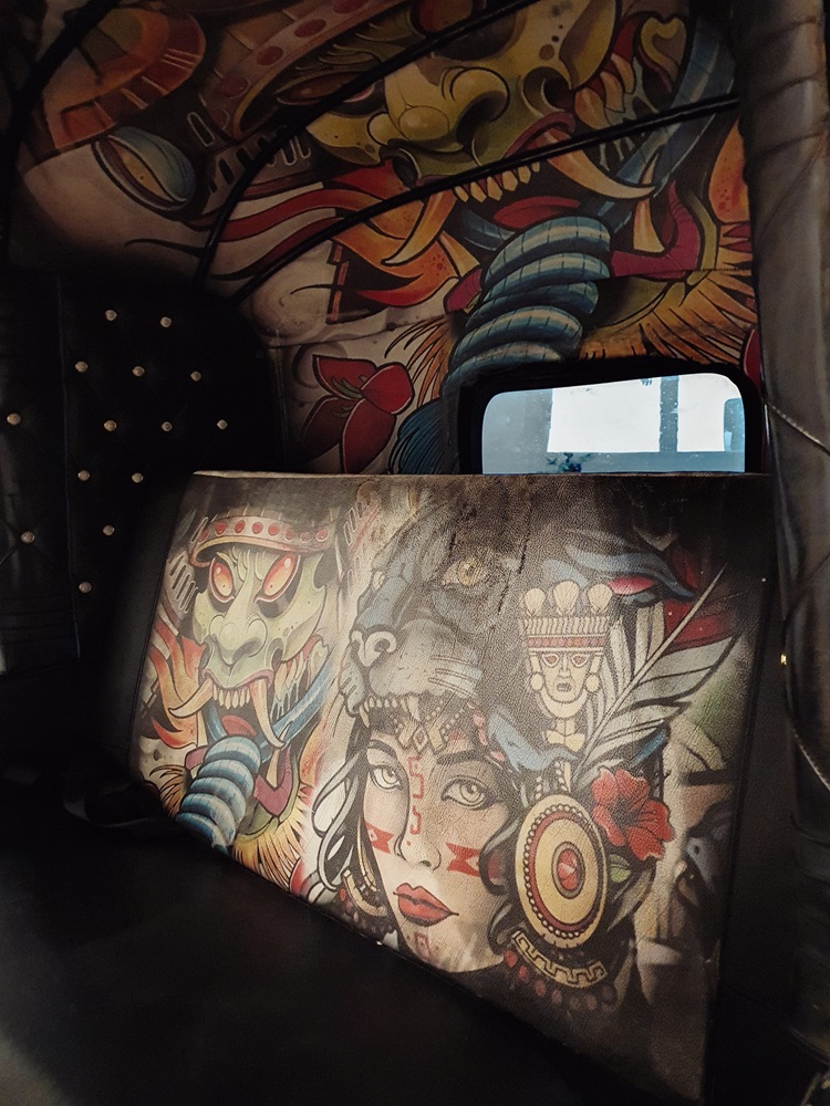 Stylised interior and seat covers of a rental tuktuk in Sri Lanka.