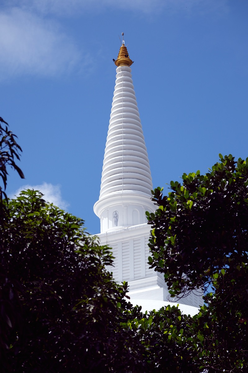 The gold-tipped spire of the Mahaseya Dagoba atop Mihintale's peak in Sri Lanka.