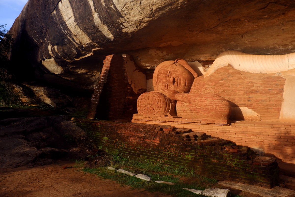 The weather-worn brick-built reclining Buddha on the Pidurangala Rock Hike in the morning light.