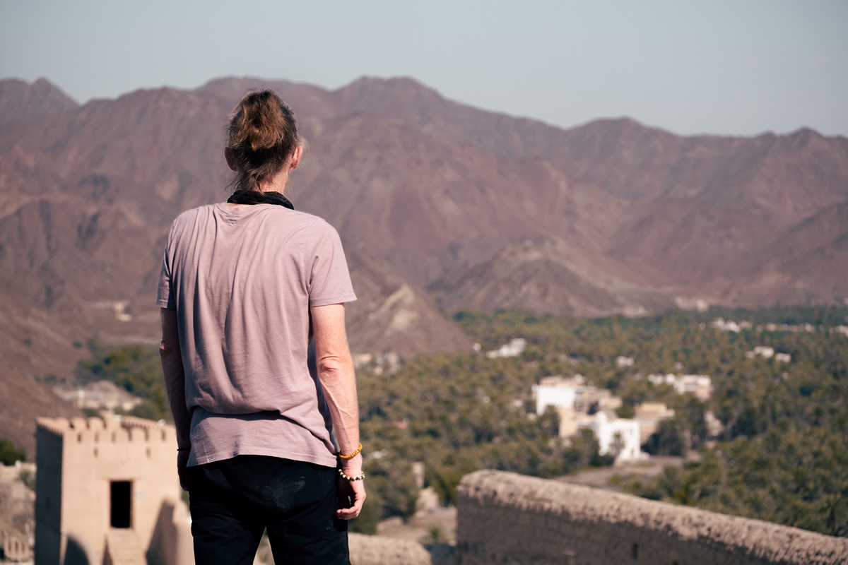 A person enjoying the views from atop Samail Castle, Oman.