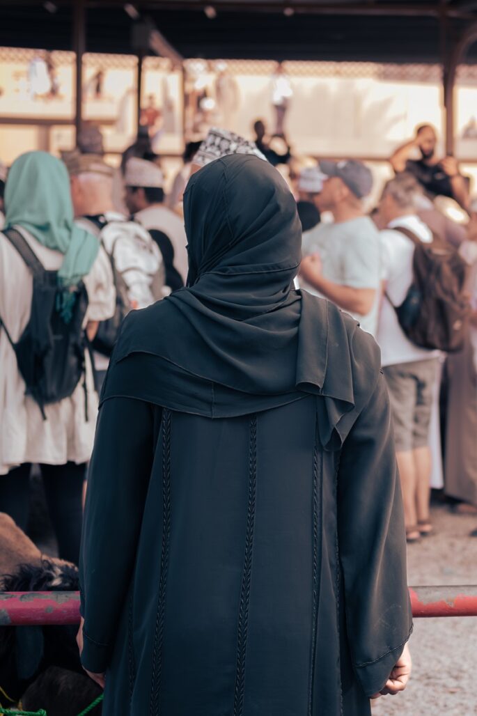An Omani woman wearing a batula, eying up the goats at the market in Nizwa.