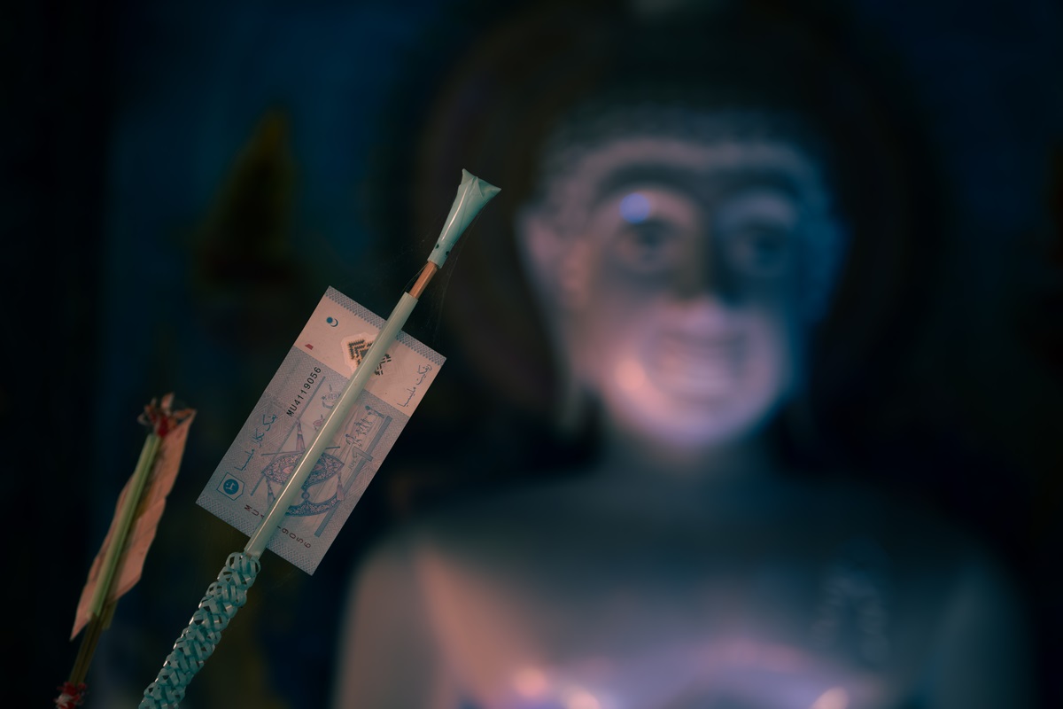 Spirit money on a money tree, offered at the Buddha shrine inside the Blue Temple, Chiang Rai.