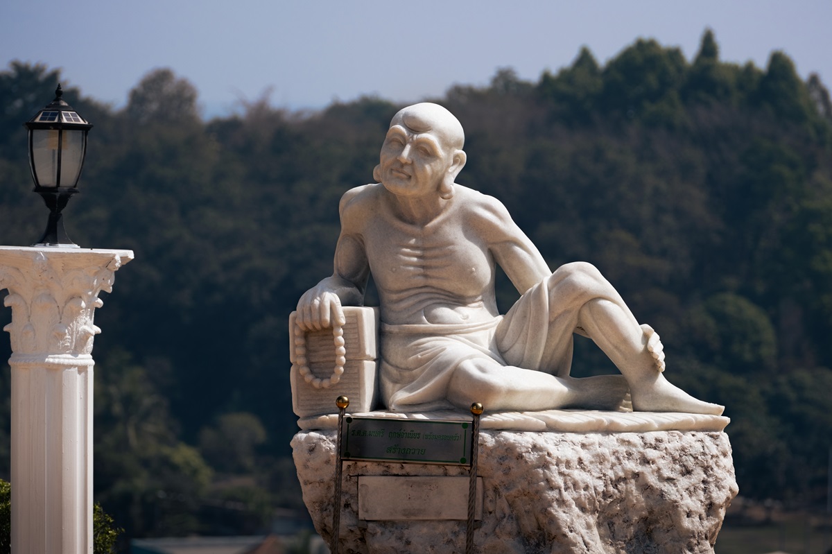 A carved statue of a wizened person at the Goddess of Mercy temple in Chaing Rai.