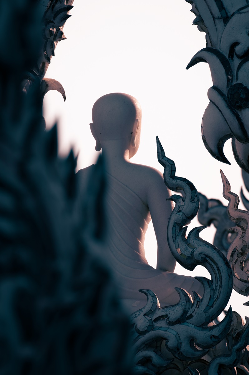 The back of a white Buddha statue at the White Temple in Chiang Rai, Thailand.