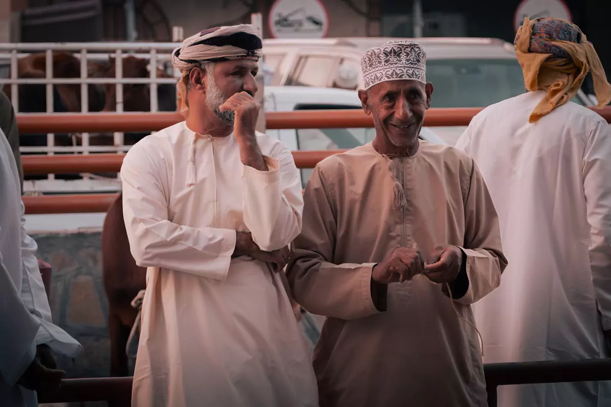 Two Omani onlookers waiting to bid on a goat at the goat market in Nizwa, Oman.