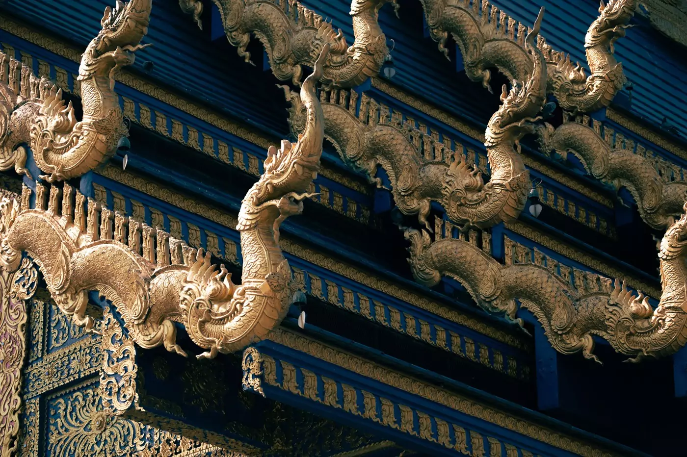 Ornate gold statues outside the Blue Temple in Chiang Rai, Thailand.