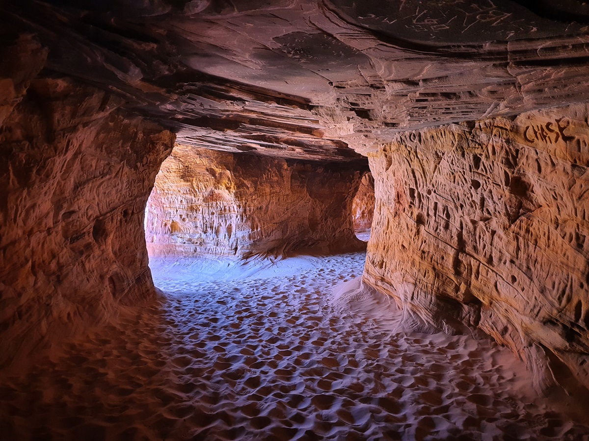 Graffiti writing on the delicate, sandstone walls inside Kanab Sand Caves, Utah.