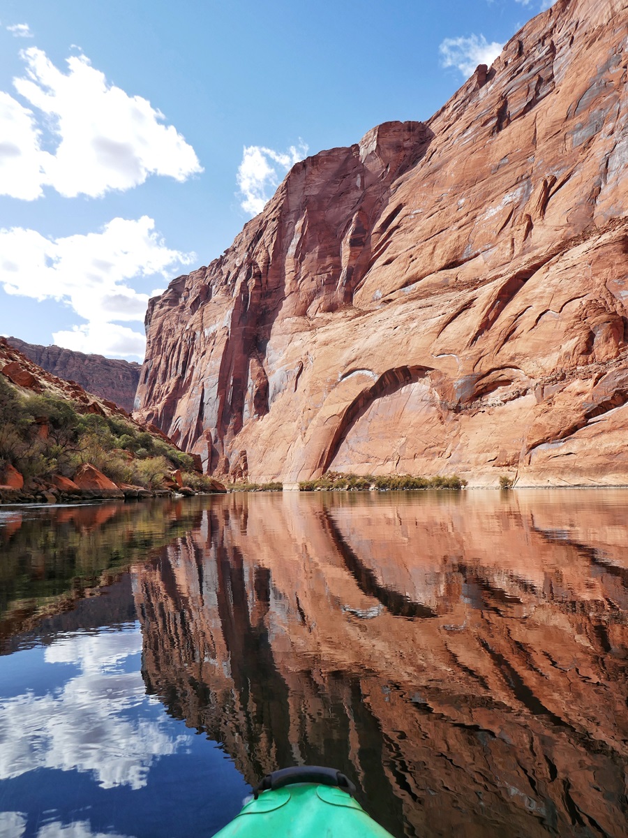 Red canyon walls reflecting in the blue waters of Horseshoe Bend near Page, Arizona.