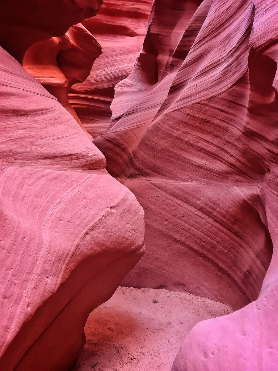 Curved, striped, canyon walls of a slot canyon in Utah.