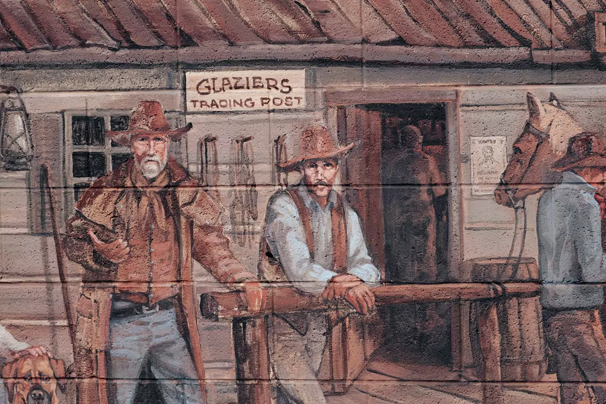 A mural outside a trading post showing a Wild West setting.