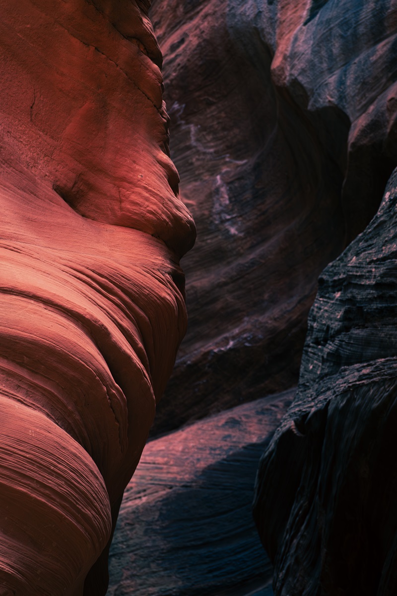 A close up of the sandstone walls of a slot canyon lit by sunlight.