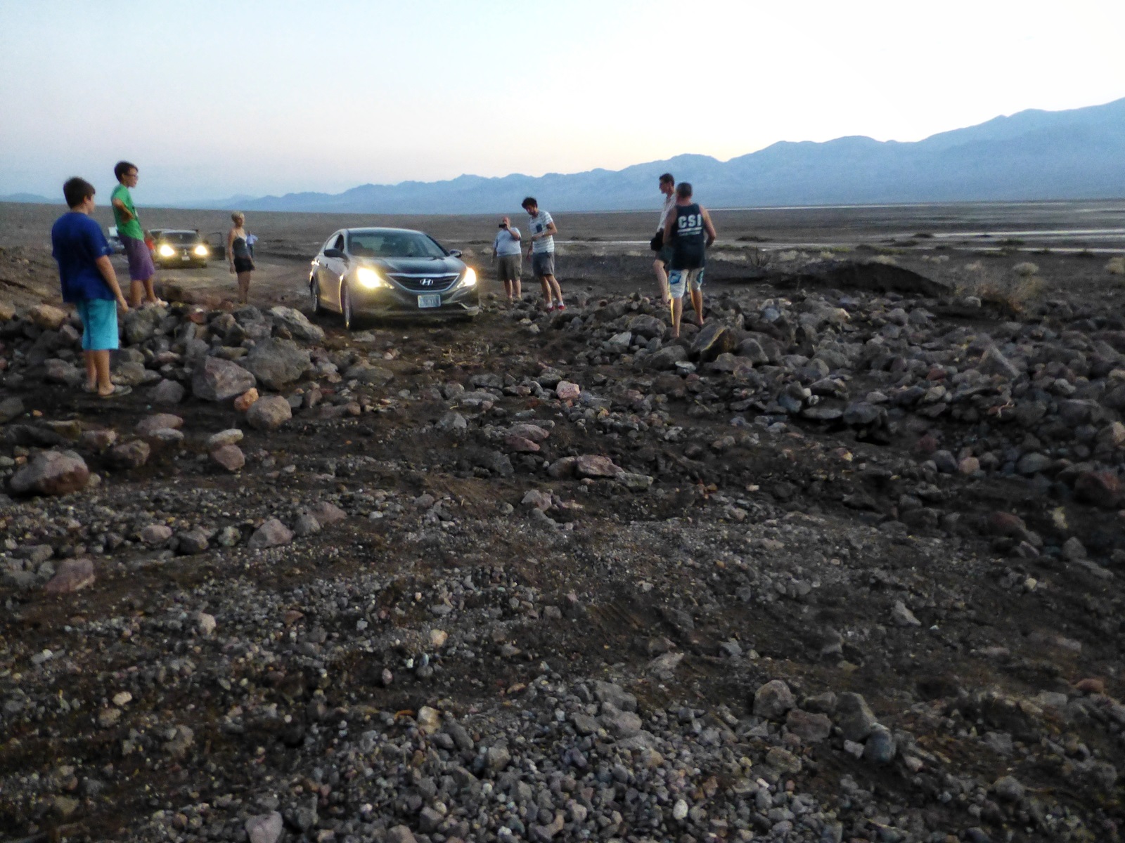Making a path through the rocky debris where the road has been swept away in Death Valley.