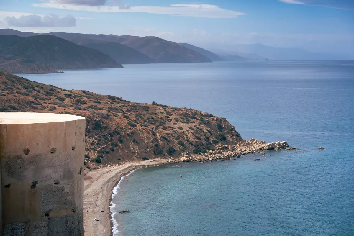 Calm views over the Mediterranean Sea of Morocco's green sea cliffs, sand beaches and blue skies.