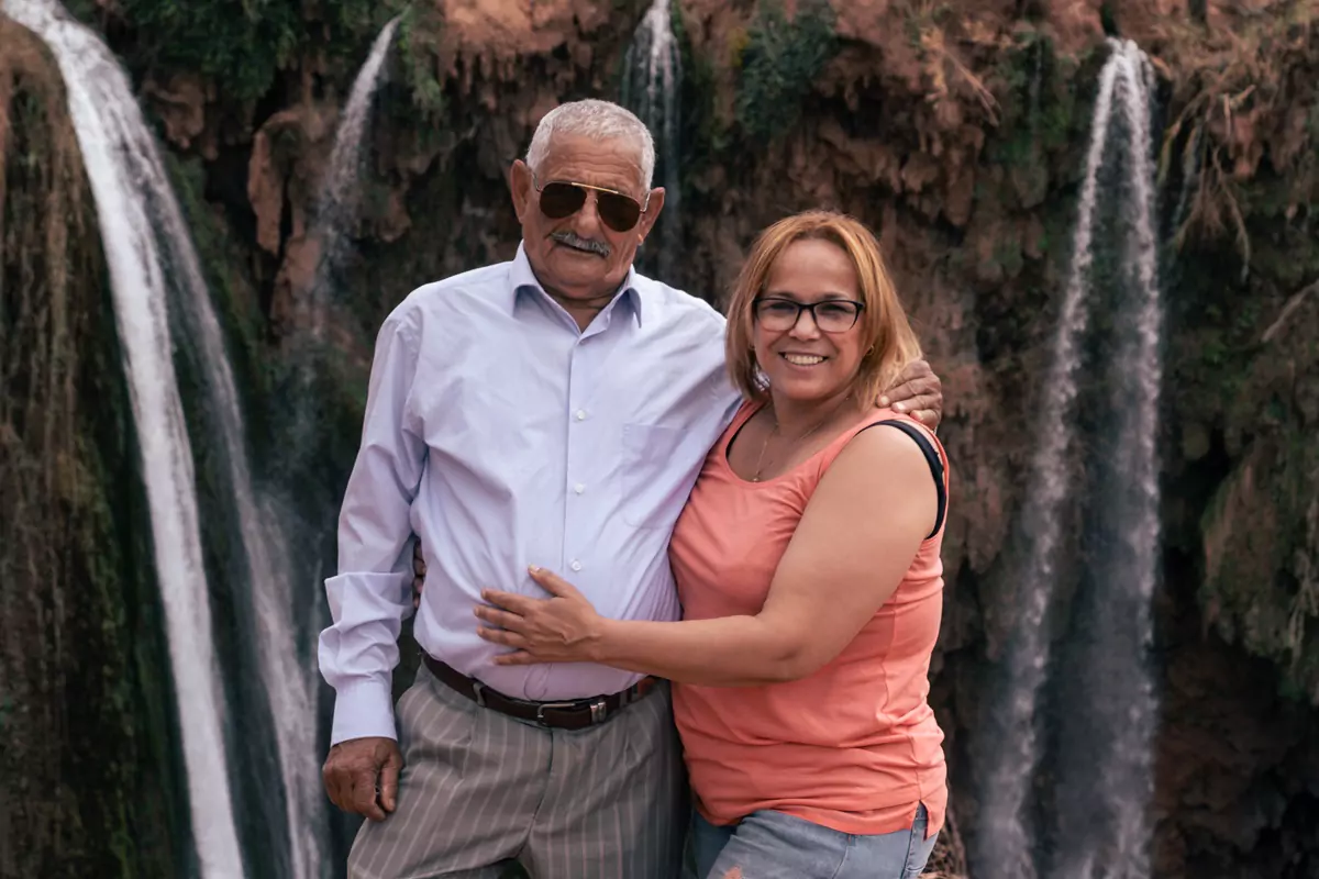 Two people posing for a photograph  at Ouzoud Falls, Morocco.