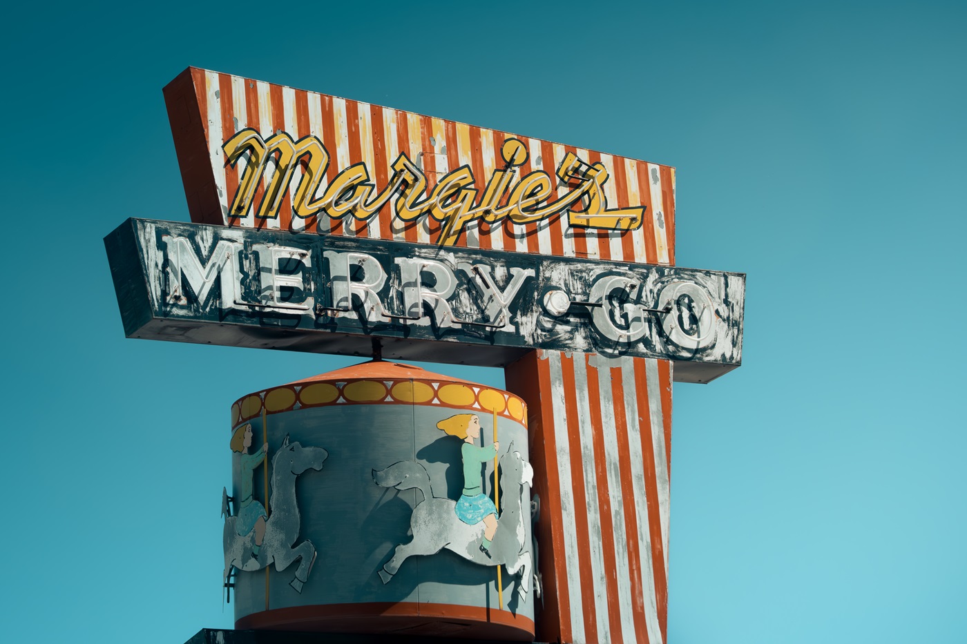 A retro sign, complete with neon lighting, for a merry-go-round, found in California.