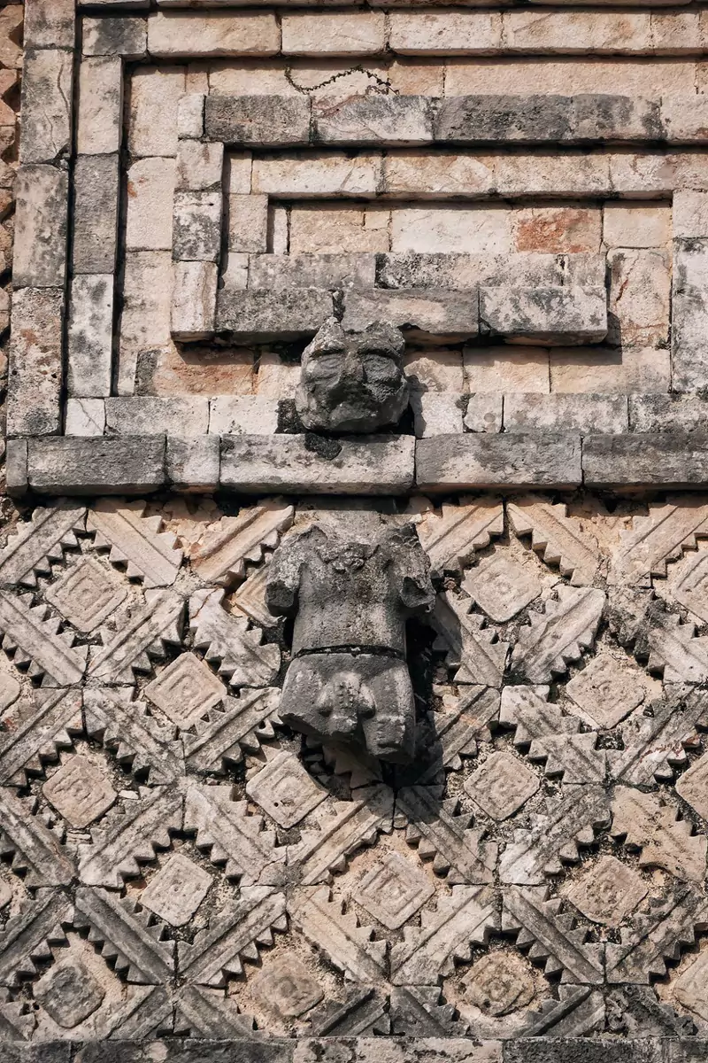 Ornate decoration of a human figure, on a structure at Uxmal, a Mayan ruin in Mexico.